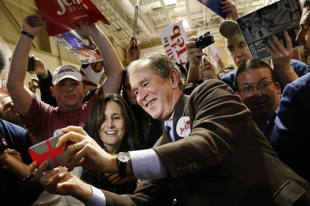 Former US president George W. Bush takes a selfie with a supporter of his brother, Republican presidential candidate Jeb Bush, at a campaign event in in Charleston, South Carolina, on Monday. Photo: Tribune News Service