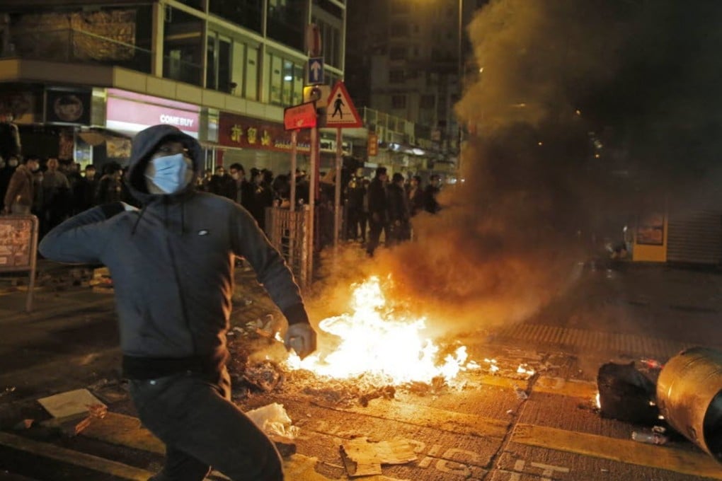 A rioter throws bricks at police in Mong Kok. Photo: AP