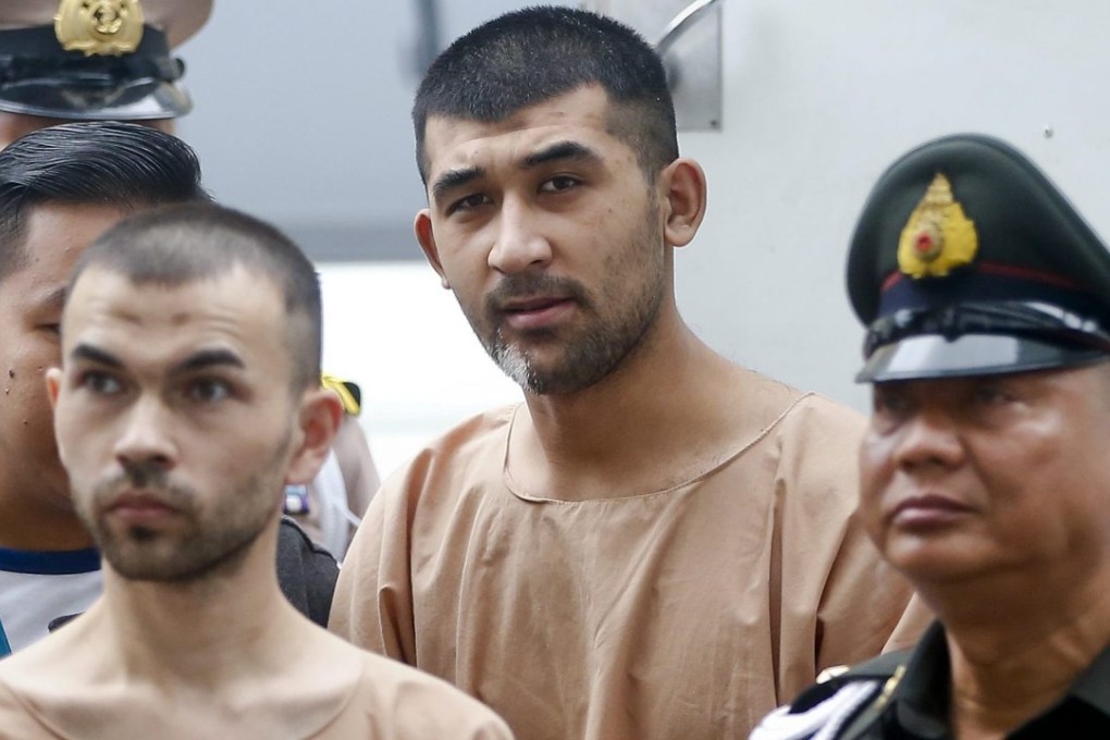 Adem Karadag (left), and Yusufu Mieraili (back) are escorted by officers and prison personnel to the Military Court, in Bangkok, Thailand. Photo: EPA