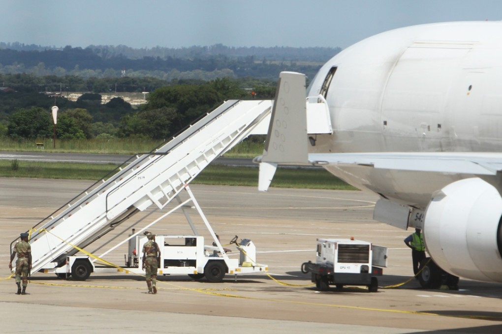 Zimbabwean soldiers patrol around a US-registered cargo plane at Harare International Airport on Monday after a dead body and millions of South African rand were found on board. Photo: AP