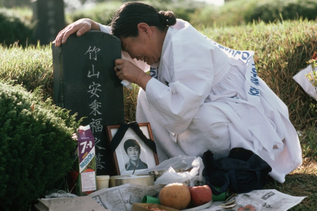 A mother weeps at the grave of her son, one of the victims of the Kwangju massacre. Photo: Corbis
