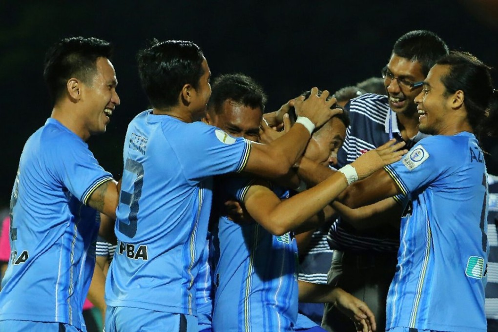 Mohd Faiz Subri is congratulated by his teammates. Photo: EPA