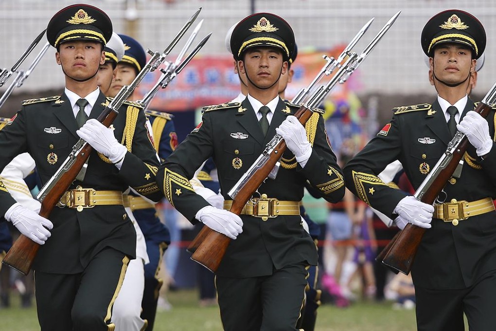 PLA soldiers parade in Hong Kong. They have kept a low profile since the handover in 1997. Photo: Sam Tsang
