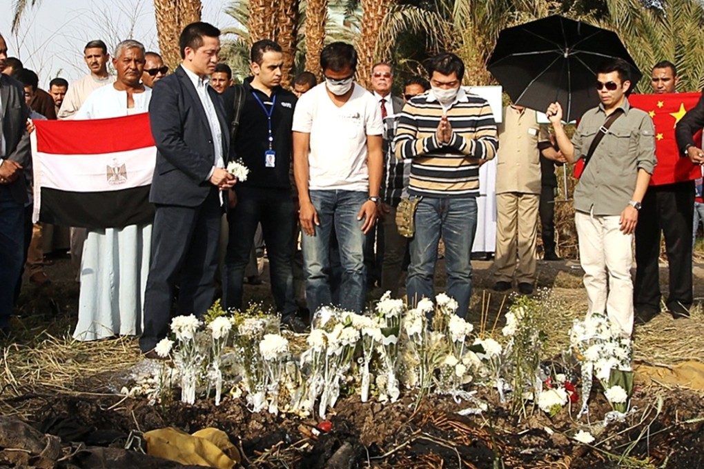 Relatives of victims attend a mourning ceremony at the crash site in Luxor. Photo: Sam Tsang