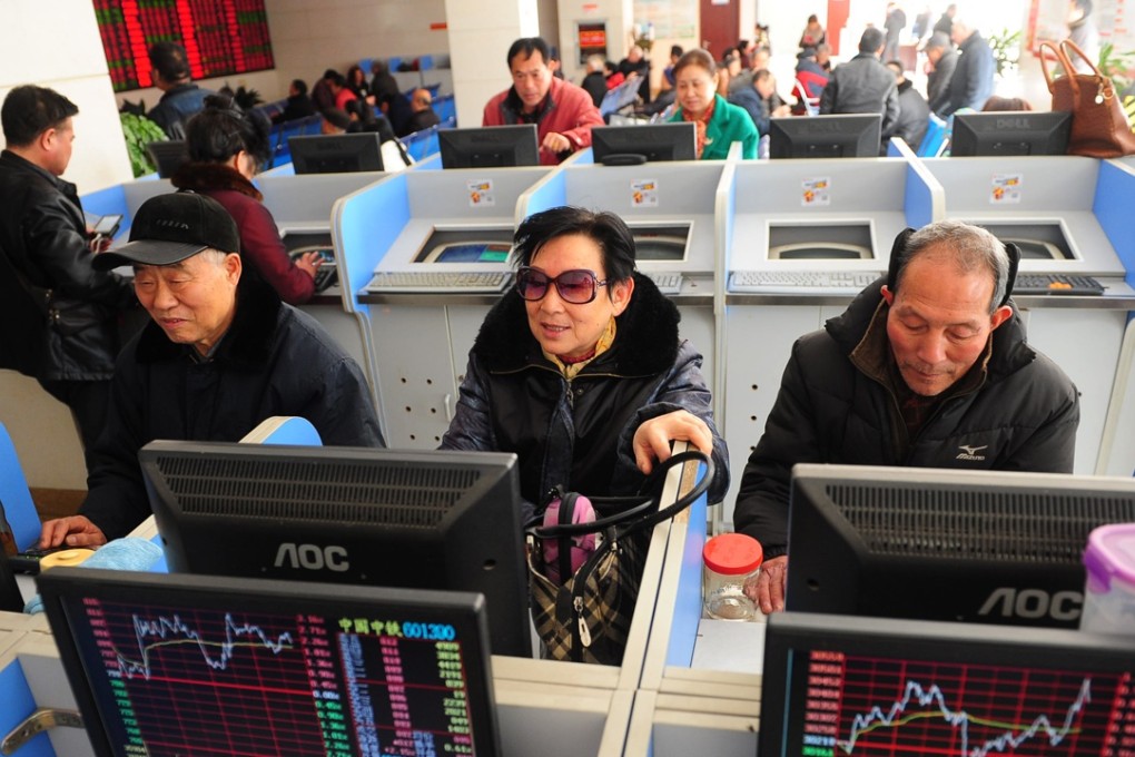 Investors watch stock movements in a securities company in Fuyang, east China's Anhui Province, on February 17. Photo: Xinhua