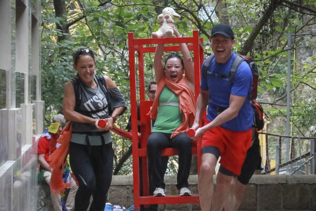A woman in a sedan chair during a charity scavenger hunt to raise funds for children’s education in Nepal.