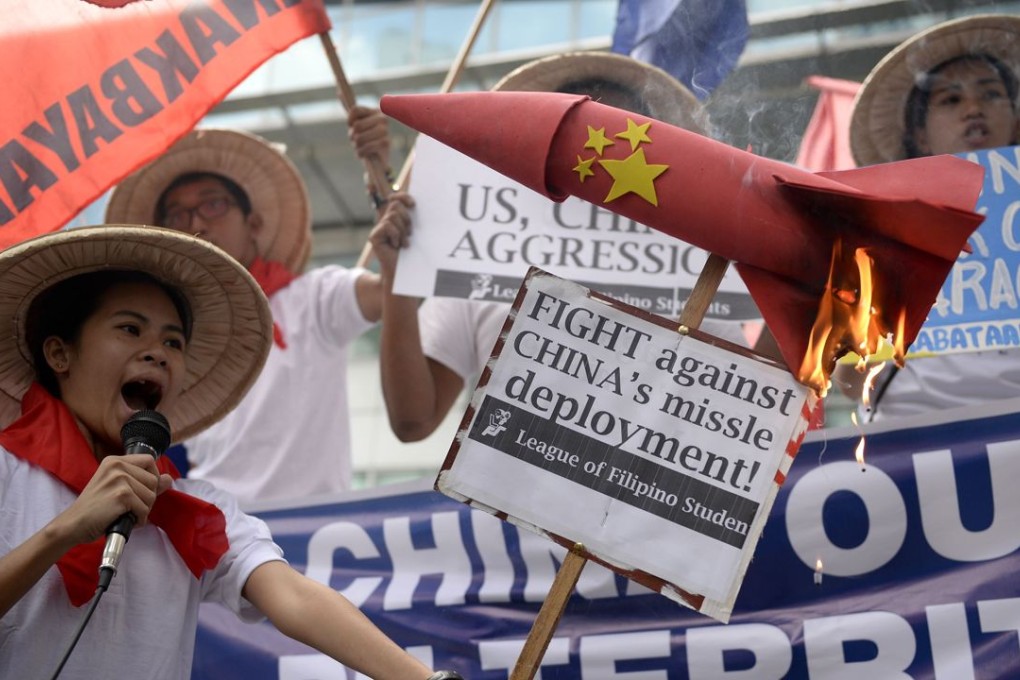 Student denounce China's deployment of surface-to-air missile system in Woody Island. Photo: AFP