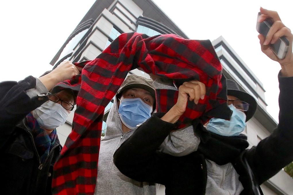 Student Ho Ying-kit (centre) appears at Kowloon City Court to face one charge of rioting. Photo: Sam Tsang.