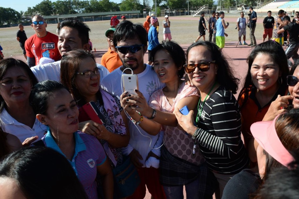 Manny Pacquiao poses for photos with fans after a training session on Friday, his popularity seemingly undented by his anti-gay remarks. Photo: AFP