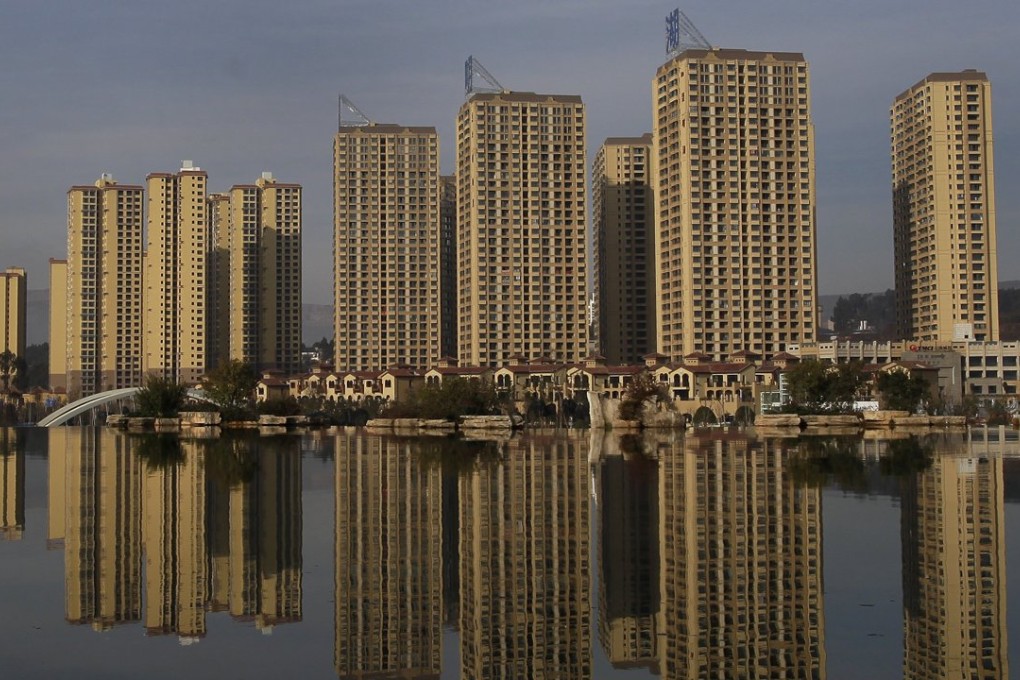 Newly constructed residential buildings are seen reflected in an artificial lake at Kunming Waterfall Park, Yunnan Province, China, on January 14,Photo: Reuters