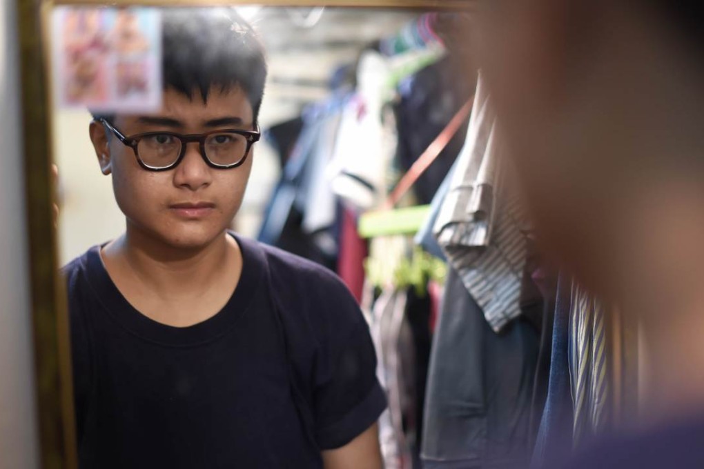 Thai transgender Chalit Pongpitakwiset, who is undergoing a hormone treatment to change into a man, pictured at his home in Bangkok. Photo: AFP