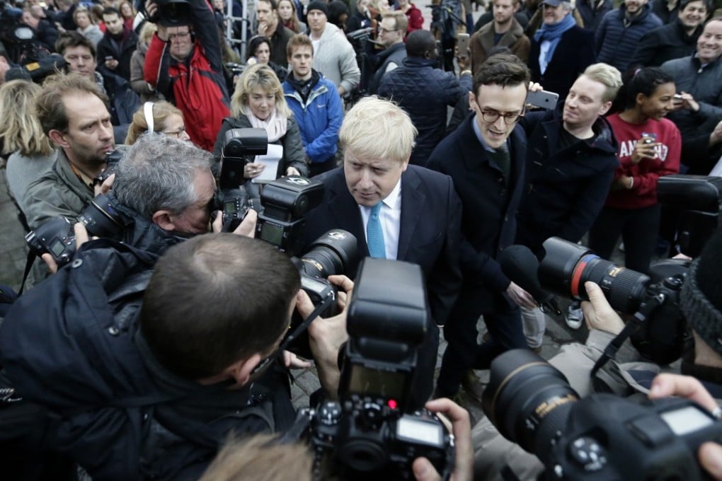 London Mayor Boris Johnson, centre, is surrounded by members of the media and onlookers outside his home on Sunday, where he announced that he would support Britain’s departure from the EU. Photo: AP