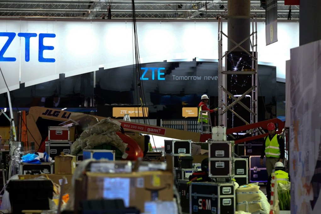 Workers make final preparations to ZTE’s stand at the Mobile World Congress in Barcelona on Saturday. Photo: Bloomberg