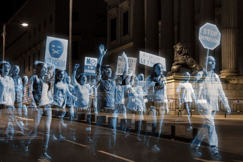 Holograms of anti-gag law protesters projected outside the Spanish parliament of Madrid. Photo: AFP