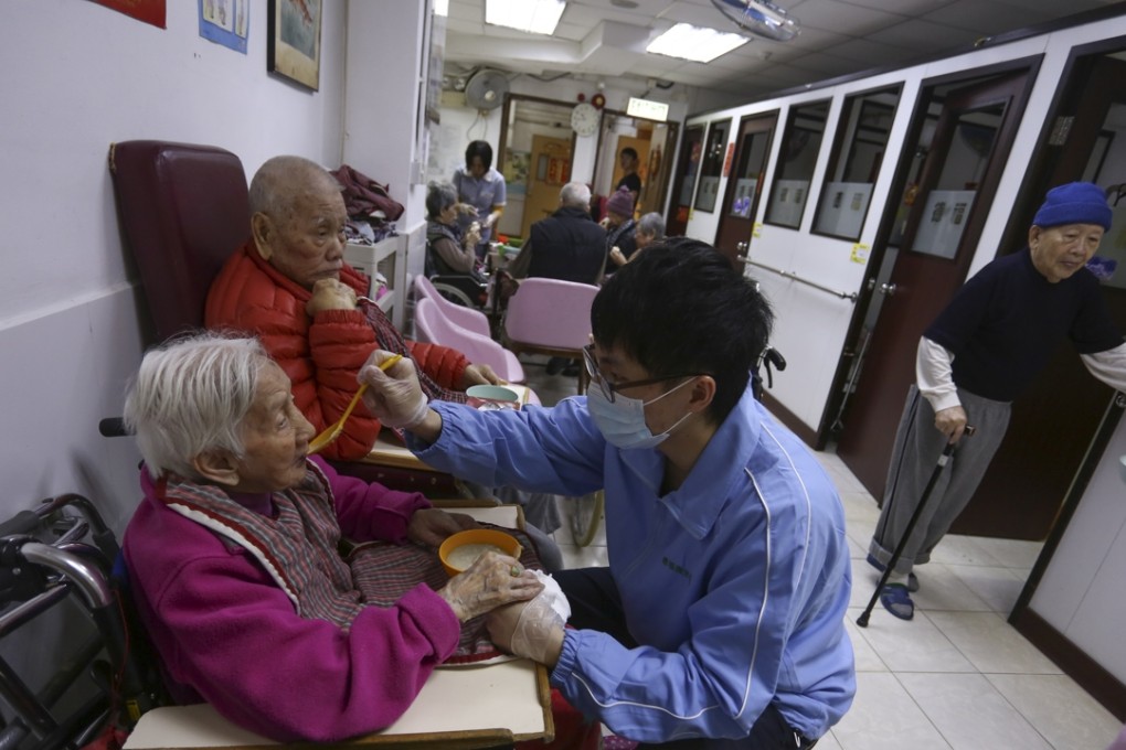 Personal care worker Chan Cheuk-man feeds an elderly patient at Telford Nursing Centre in Sham Shui Po. Photos: Jonathan Wong