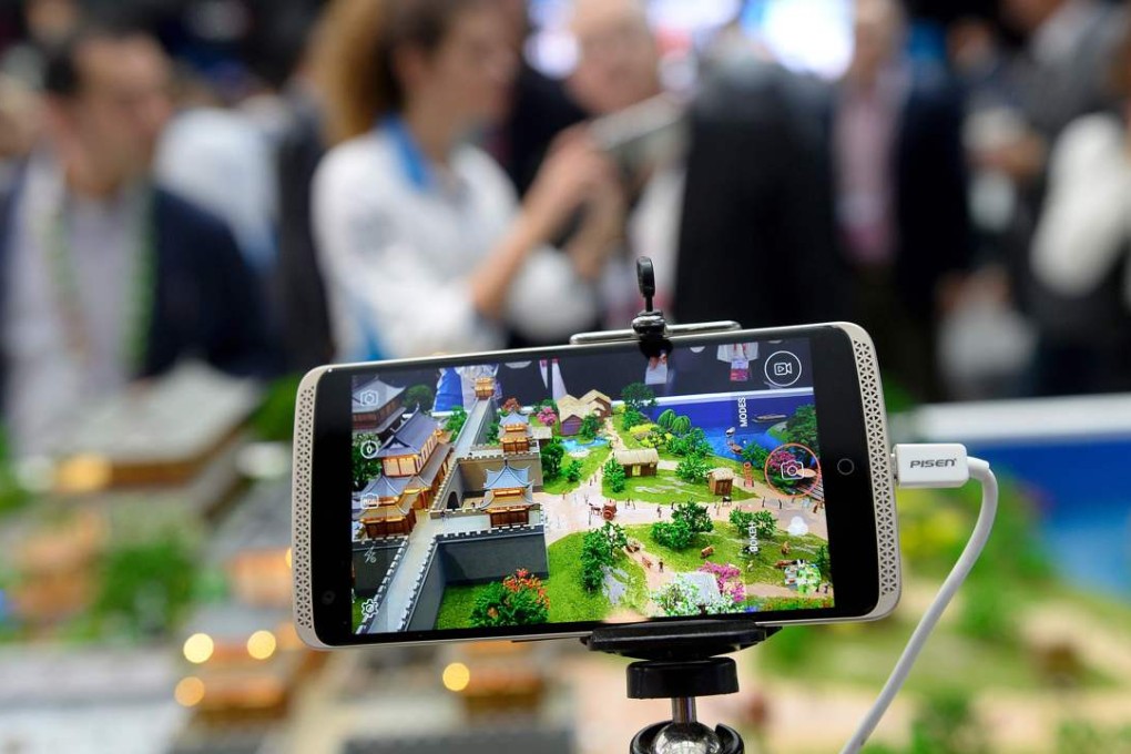 Visitors test out ZTE smartphones with 4K video at the Mobile World Congress in Barcelona yesterday. The world's biggest mobile fair runs till Thursday. Photo: AFP