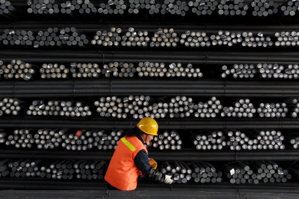 A Chinese labourer marks steel bars at a steel and iron factory in Huaian in Jiangsu province. Photo: Reuters
