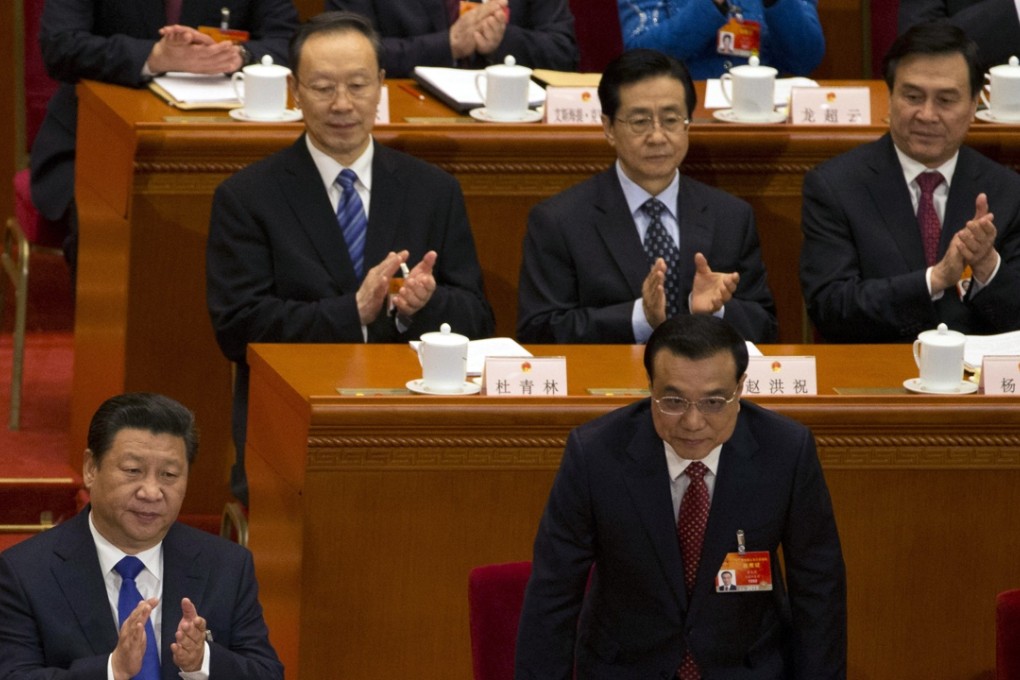Premier Li Keqiang, front right, rises from his seat near President Xi Jinping, front left, during the opening session of the National People's Congress at the Great Hall of the People in Beijing last year. Monday’s Politburo meeting discussed and approved Li’s government work report to be delivered at the upcoming NPC session. Photo: AP