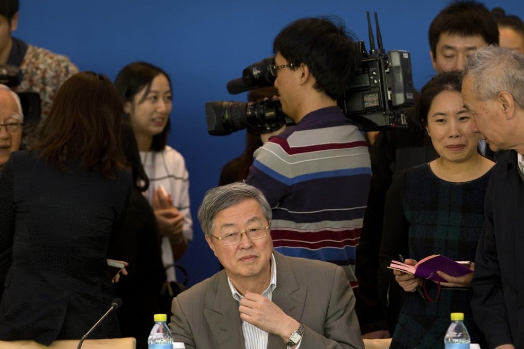 People's Bank of China governor Zhou Xiaochuan, centre, sits before the start of a meeting of the Chinese Economists 50 Forum at the Diaoyutai State Guesthouse in Beijing on Friday. Photo: AP Photo