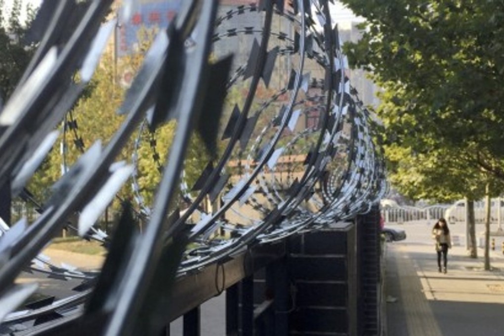 Barbed wire protects a residential compound in Beijing. The Chinese government plans to open all gated communities to the public, causing concerns over security and private property rights. Photo: Simon Song