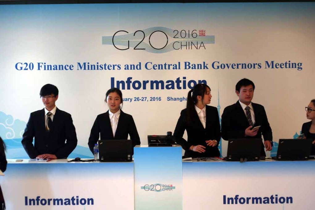 Chinese hostesses and receptionists work at the information desk for the 2016 G20 Finance Ministers and Central Bank Governors Meeting at the Pudong Shangri-La in Shanghai. Photo: Imaginechina