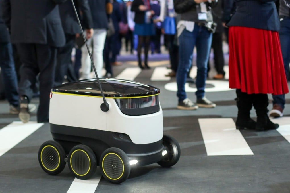 A prototype of a self-driving delivery robot developed by Starship Technologies navigates through a crowd at the Mobile World Congress in Barcelona, Spain, on Tuesday. Photo: Bloomberg