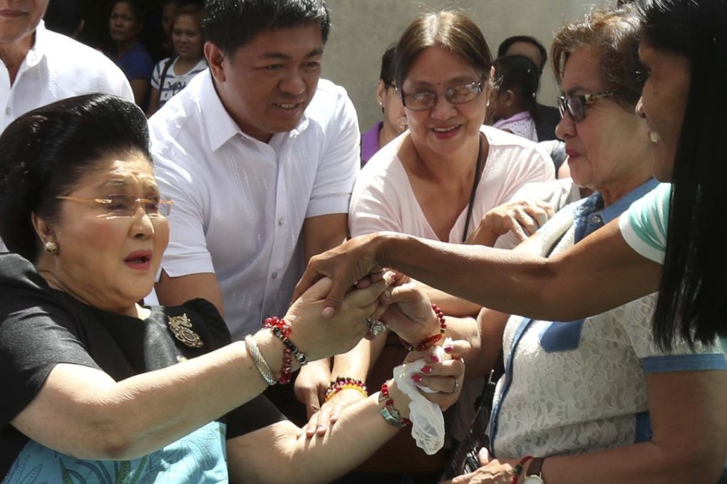 Former Philippine First Lady Imelda Marcos on a wheelchair greets supporters after attending a mass at the National Shrine of Our Mother of Perpetual Help in Paranaque city, Metro Manila. Photo: Reuters