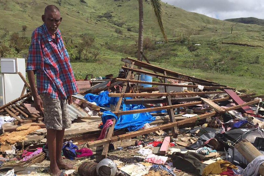 Naresh Kumar amid the ruins of his house after Cyclone Winston hit. Photo: AFP