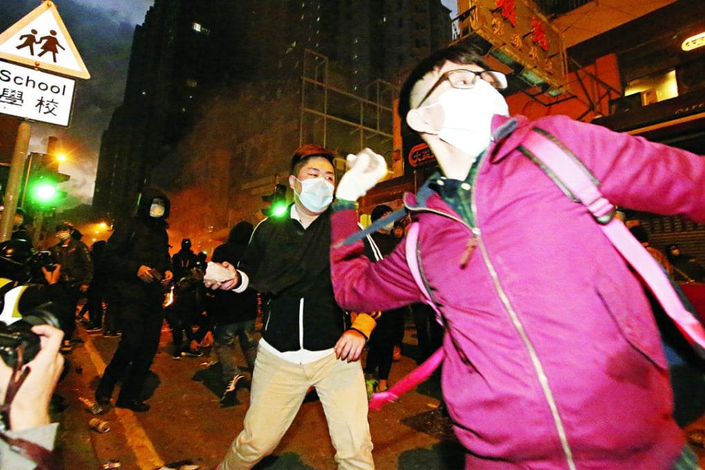 Rioters throw bricks in Mong Kok during the recent protest. Photo: Edward Wong