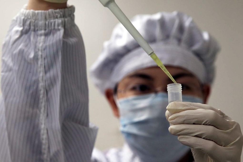 A file picture of a biotechnology worker in China. Gene editing techniques have already been used to create more muscular dogs and pigs with leaner meat. Photo: EPA