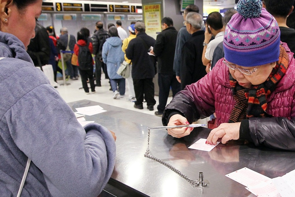 Lottery players at a Hong Kong Jockey club off-course betting branch in Central. Photo: Edward Wong