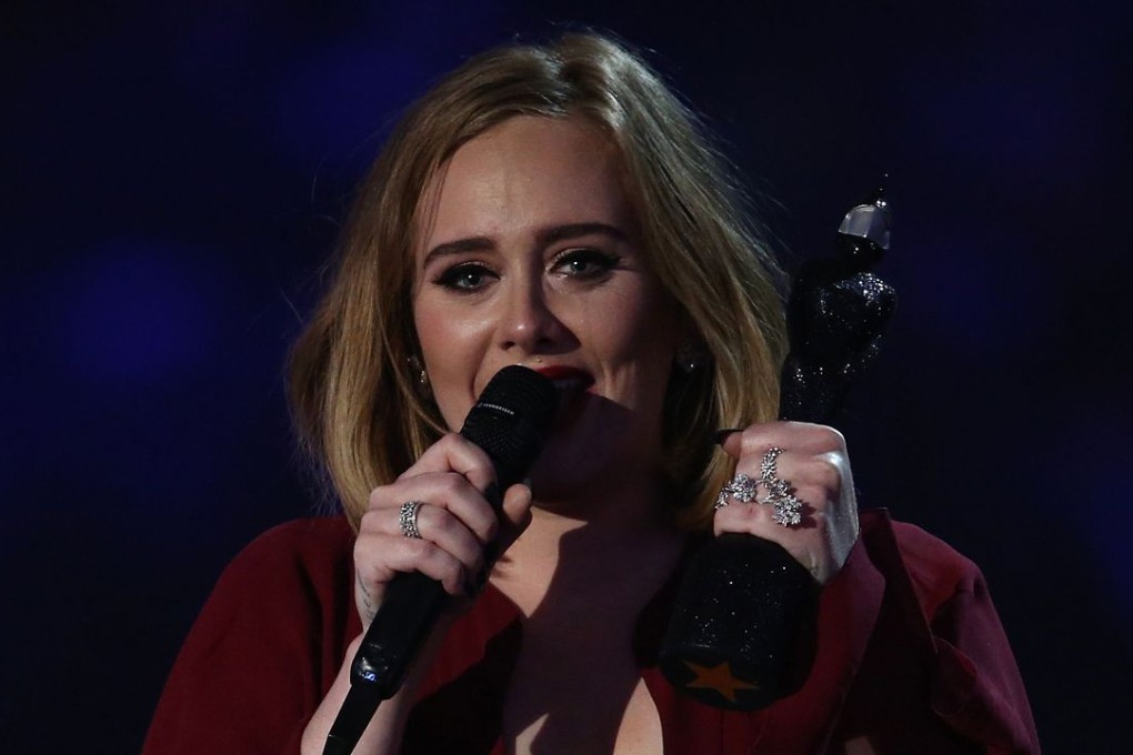 Tears run down the face of British singer Adele as she reacts after receiving the Global Success award during the BRIT Awards 2016 in London on Wednesday. Photo: AFP