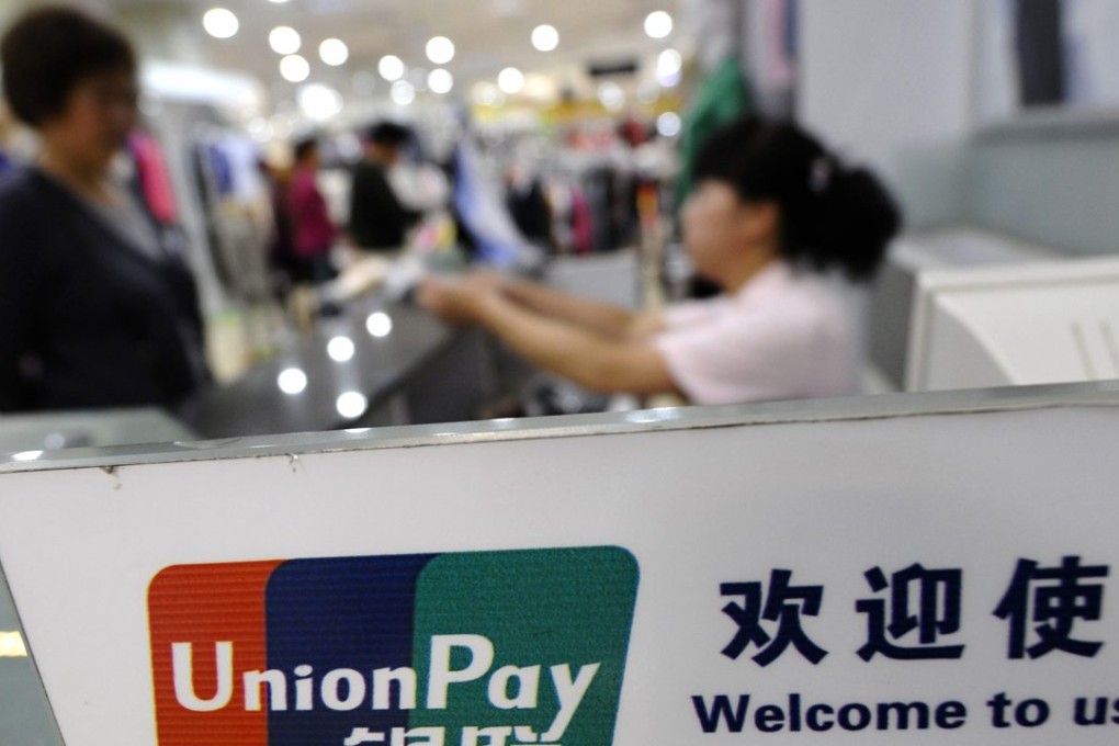 The logo of Chinese bank card operator UnionPay is seen at a cashier at a shopping mall in Shanxi province as Beijing’s tightening of capital controls is seen harmful to Hong Kong’s financial sector. Photo: Reuters