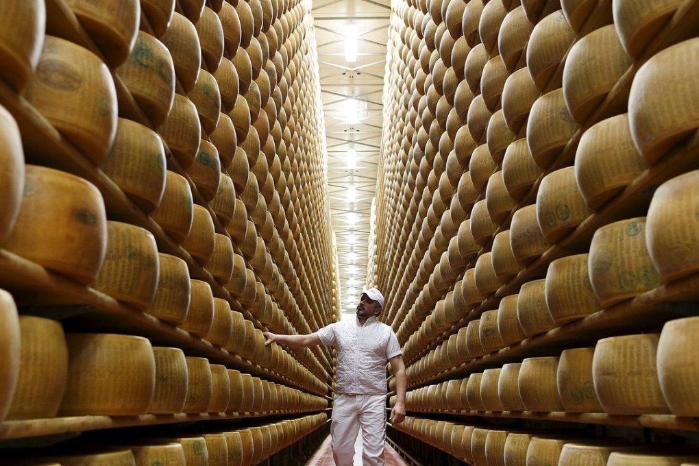 The real thing. A worker inspects wheels of Parmesan cheese at a storehouse in Modena, Italy. Photo: Reuters