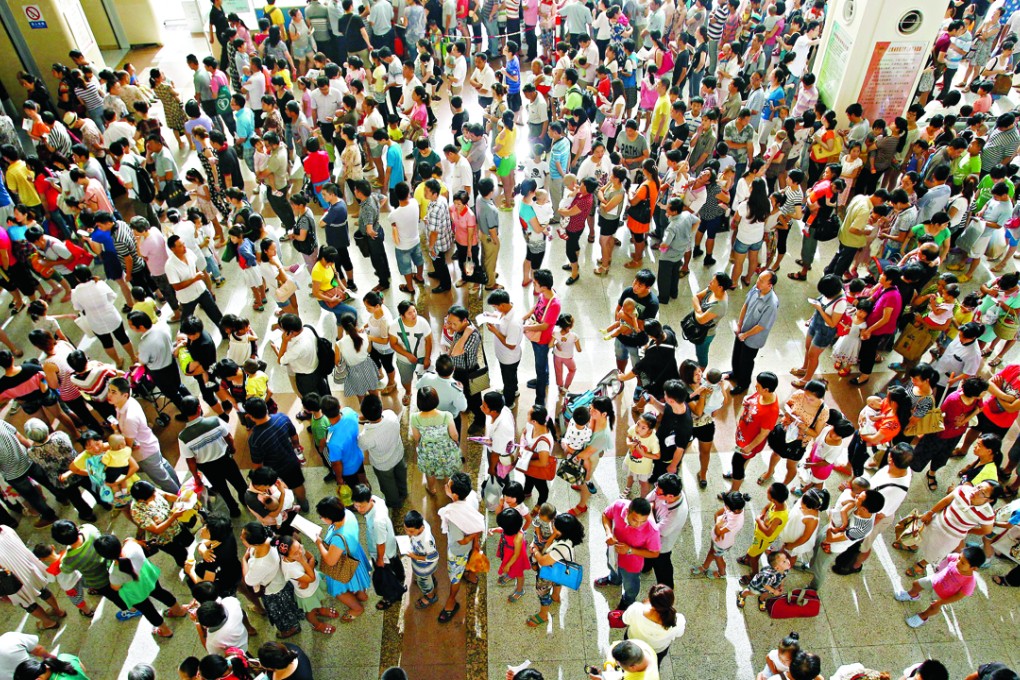 Parents queue to register their children at the Children’s Hospital Affiliated to Fudan University, in Shanghai. Photo: Xinhua