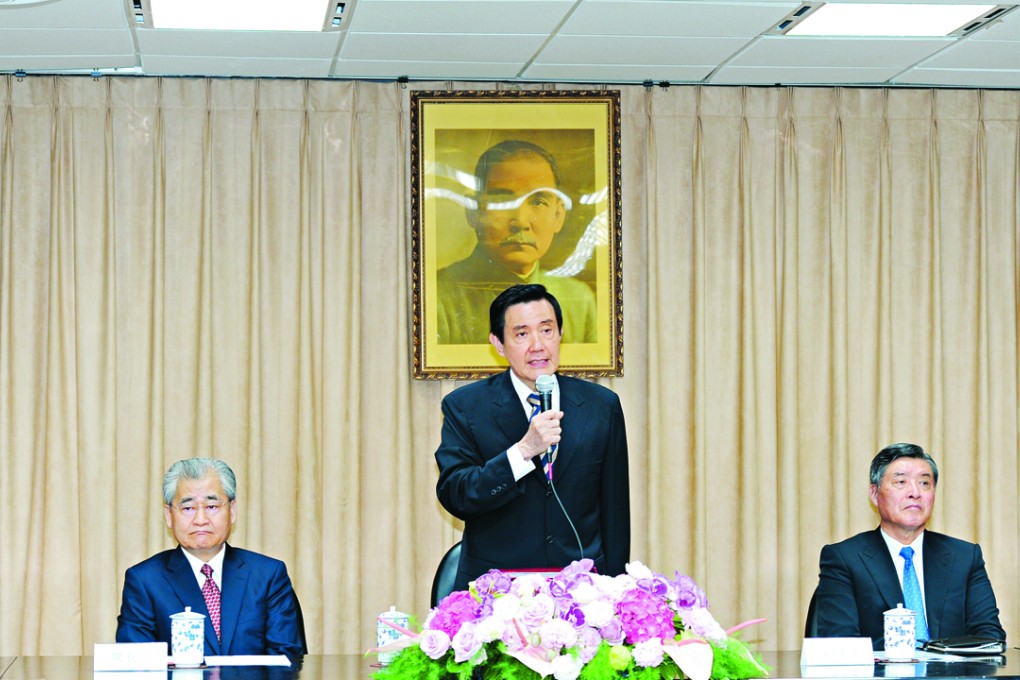 Taiwan president Ma Ying-jeou (centre) stands in front of a portrait of Sun Yat-sen, the late founder of the Republic of China.