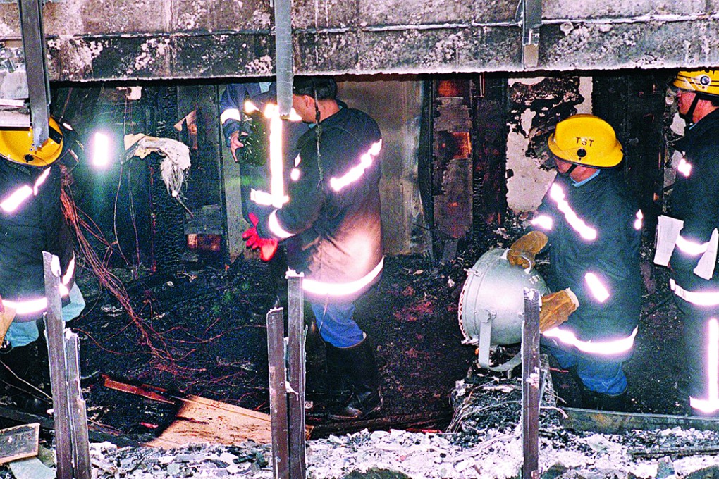 Fire officers investigate the Top One Karaoke Box arson attack in Tsim Sha Tsui, that killed 17 people and injured 13, in 1997. Photo: SMP Pictures