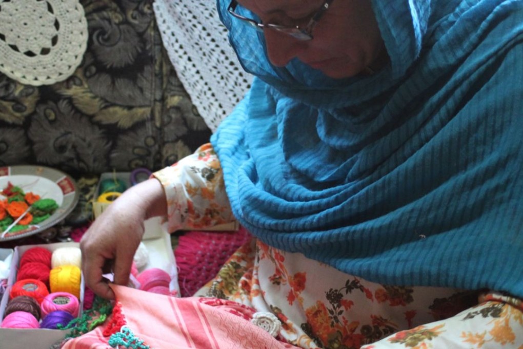 A Pakistani Chitrali woman, who works with the artisan brand Kai, stitching a scarf in Chitral in the Khyber-Pakhtunkhwa province. Photo: AFP