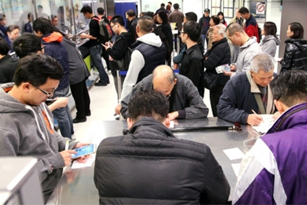 People playing the lottery at Hong Kong Jockey club. Photo: Edward Wong
