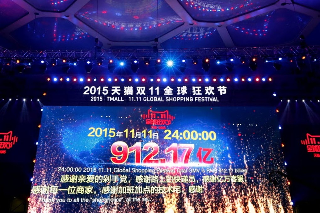 Journalists film a giant screen showing total sales transactions by e-commerce giant Alibaba, during the “Singles’ Day” global online shopping festival in November. Photo: AP