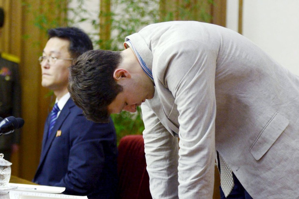 Otto Frederick Warmbier (right), a University of Virginia student who has been detained in North Korea since early January, bows during a new conference in Pyongyang. Photo: Reuters/Kyodo