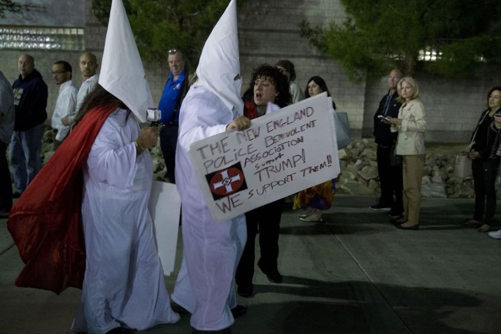 A caucus-goer confronts men dressed as Ku Klux Klan members outside the Cimarron-Memorial High School caucus location during the Nevada Republican presidential caucus in Las Vegas last Tuesday, Feb. 23, 2016.Photo: Bloomberg