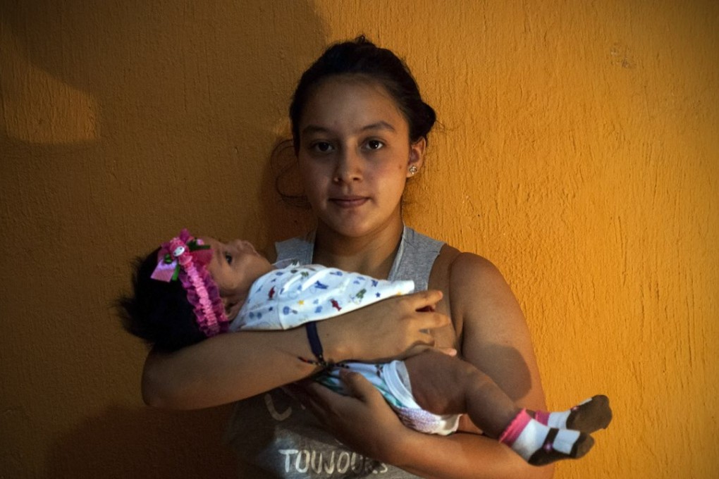 Angela Martinez cradles daughter Dominic Andrade, who suffers microcephaly, in Quito, capital of Ecuador. The condition has been linked to the mosquito-borne Zika virus. Photo: Xinhua