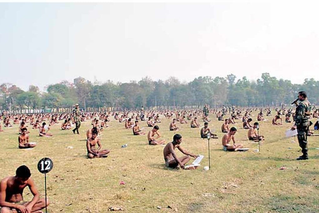 Images in the Indian Express showed dozens of men sitting cross-legged in a field clad only in underpants.