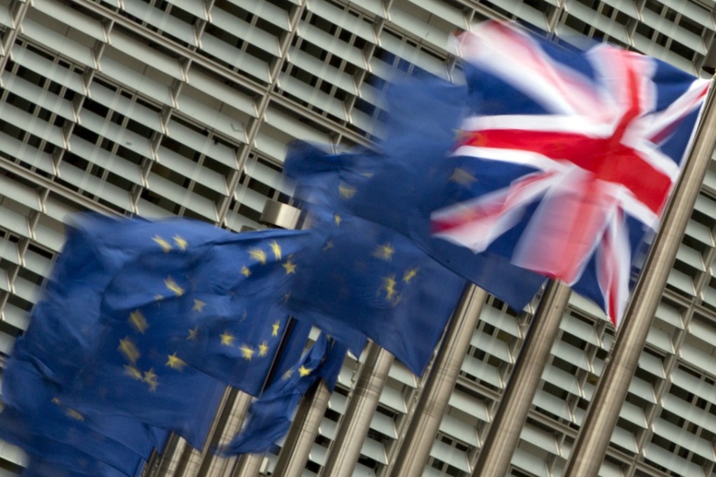 British and EU flags flapping in the wind outside the EU headquarters in Brussels. Photo: AP