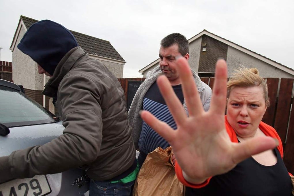 Seamus Daly (centre) walks to a car after being released from Maghaberry prison near Belfast, Northern Ireland Tuesday. Photo: AFP