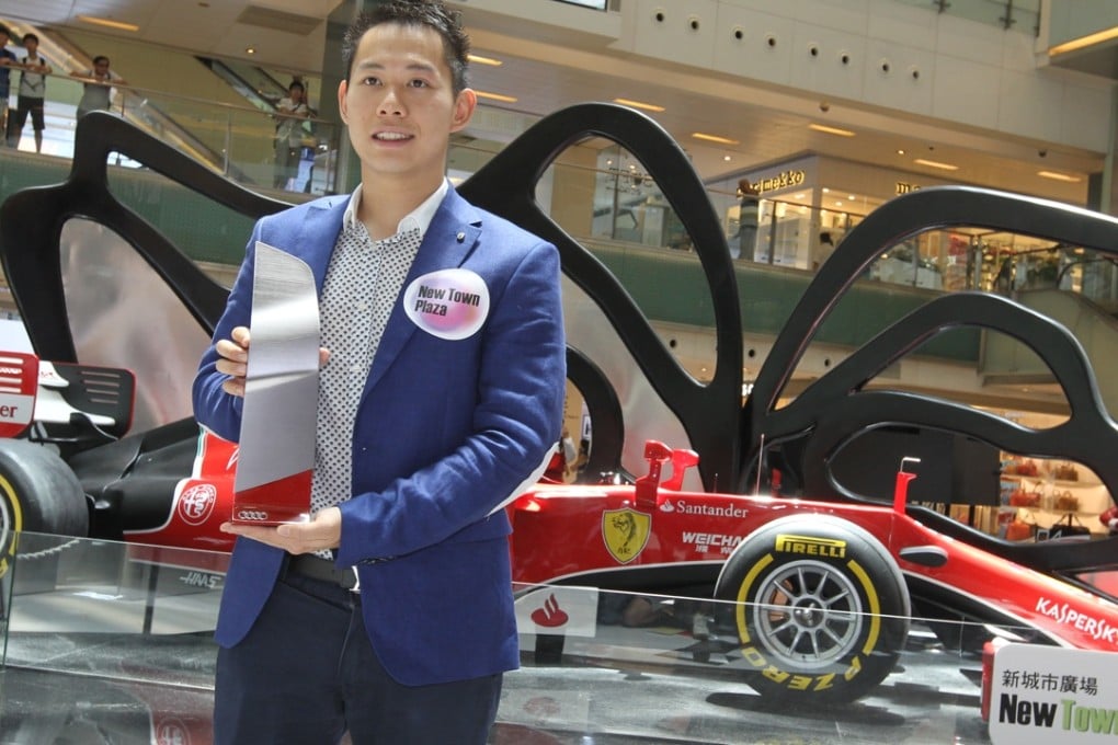 Adderly Fong poses next to an F1 car at a promo event in Sha Tin last August; he still hopes to return to the cockpit of one soon. Photo: SCMP