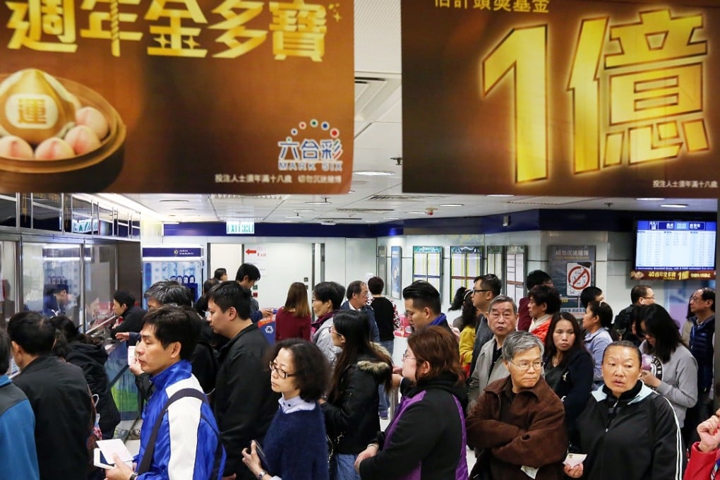 A queue for Mark Six lottery tickets bending around a street corner in Central on Tuesday. Photo: Nora Tam