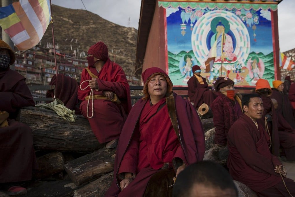 Tibetan Buddhist monks take a break at a Buddhist laymen lodge in Kardze, where the latest self-immolation occurred. Photo: Reuters