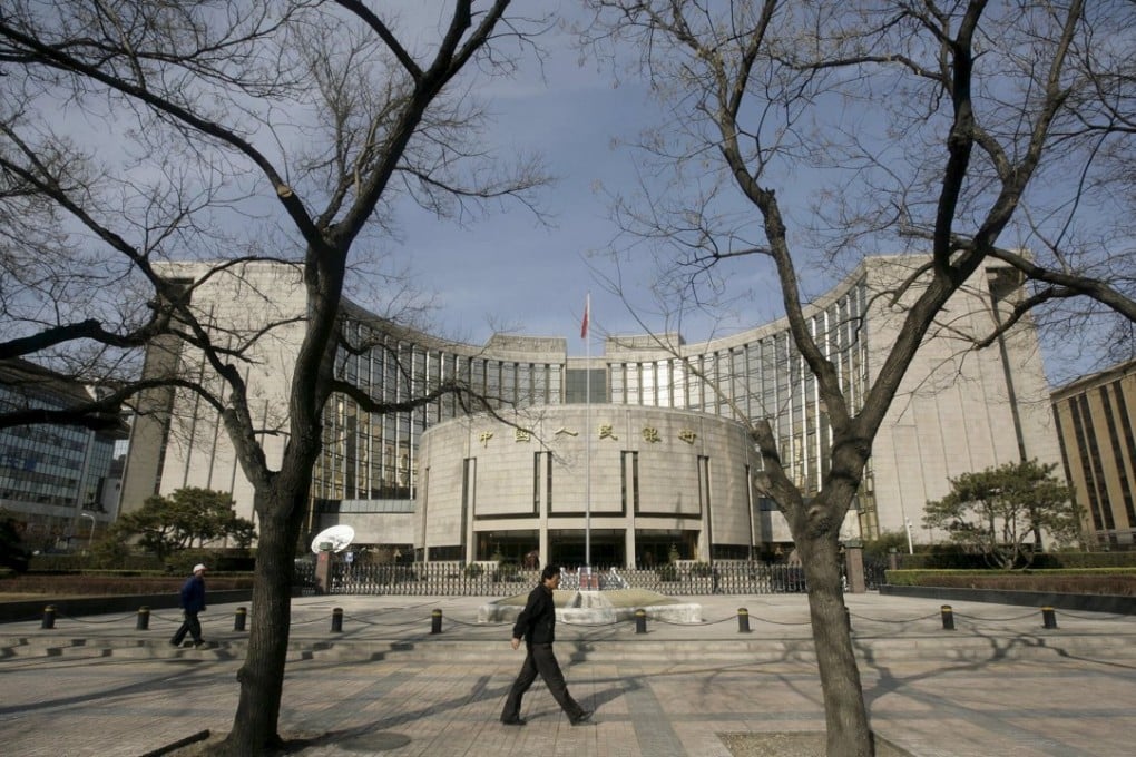 People walk past the headquarters of the People's Bank of China in Beijing. Photo: Reuters